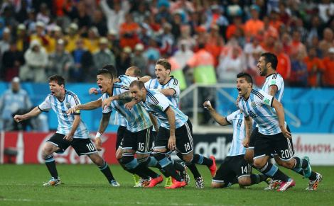 Argentina players celebrate as they win the penalty shoot out and qualify for the final to face Germany