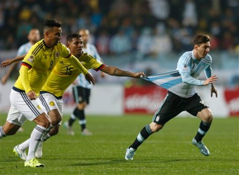 Colombia's Alexander Mejia tries to stop Argentina's Lionel Messi by pulling his jersey during a Copa America quarterfinal soccer match at the Sausalito Stadium in Vina del Mar, Chile, Friday, June 26, 2015. (AP Photo/Andre Penner)