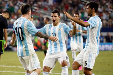 Argentina's Lionel Messi, left, celebrates with teammate Sergio Aguero after scoring his team's second goal during a friendly soccer match against Mexico at the AT&T Stadium in Arlington, Texas, Tuesday, Sept. 8, 2015. (AP Photo/Tony Gutierrez)